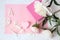 Gift with a picture-hearts, delicate peonies on a pink background, space for text, top view-the concept of congratulations on