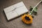 Gift or present box in craft paper and fresh sunflower on table top view. Flat lay styling. Holiday concept. Interior decoration
