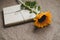 Gift or present box in craft paper and fresh sunflower on table top view. Flat lay styling. Holiday concept. Interior decoration