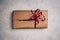 Gift or present in brown paper box with red ribbon, above view