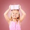 Gift, present and child with box on head for birthday, holiday or happy celebration. Portrait of excited girl on a pink