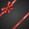 Gift realistic red bow and ribbons tilted on a black background. Beautiful vector illustration EPS 10
