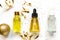 Gift set of beauty face oils with natural essential oil, hyaluron, vitamin C decorated with festive golden streamers, confetti and