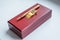 Gift set. holder clip for money. stationery. wooden present box. golden money clip. A pen in a gift box on white