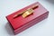 Gift set. holder clip for money. stationery. wooden present box. golden money clip. A pen in a gift box on white