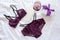 Gift, shopping and fashion concept. Set of glamorous stylish lace lingerie on bed with giftbox and wineglass on
