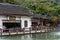 Gift shops in the Chinese ancient house with The Tianxing lake and fountain, in the National park of Huangguoshu waterfall, in