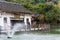 Gift shops in the Chinese ancient house with The Tianxing lake and fountain, in the National park of Huangguoshu waterfalls