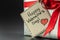 Gift in silver packaging with red ribbon and greetings with Valentine`s day