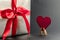 Gift in silver packaging with red ribbon and greetings with Valentine`s day
