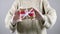 Gift wrapping with rubber gloves. Girl holding gift wrap in rubber gloves