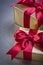 Giftboxes in glittery paper on grey background vertical view hol