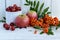 Gifts of autumn: apples, cherry plum, mountain ash on a white background.