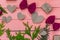 Gifts, bows and hearts on pink wooden background
