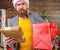 Gifts delivery service. Post for santa claus. Man bearded hipster wear santa hat hold bunch of letters and gift box