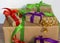 Gifts packed in craft paper and tied with satin ribbon on a wooden background. Birthday presents, new year and christmas.