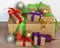 Gifts are packed in kraft paper and tied with a satin ribbon with New Year`s toys on a wooden background.