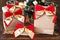 Gifts paper package with red golden bow near small Christmas tree