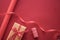 Gifts preparation, birthday and holidays gift giving, craft paper and ribbons for gift boxes on coral background as