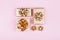 Gifts or presents boxes with golden bows on pink pastel background top view. Flat lay for birthday, christmas or wedding.