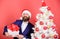 Gifts shop. Christmas party. Man bearded hipster formal suit christmas tree hold gift box. Christmas gifts. Winter