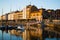 Gijon, Asturias, Spain; 09/26/2018: Sunset in the dock of Gijon, Asturias, Spain, with the reflections of the buildings in the