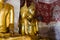 Gild Buddha Sculptures at Ancient Veranda of Wat Suthat, Bangkok of Thailand.