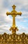 Gilded crown and cross of the dome of the Basilica of Our Lady of the Rosary of Lourdes, France.