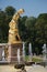 Gilded female statue. The sculptural ensemble of the Grand Cascade on a sunny day, close-up. Peterhof