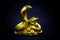 Gilded figure: snake and toad on a black background. Side view