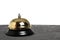 Gilded hotel service bell on a white background, isolate