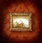 Gilded picture frame on antique wallpaper