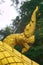 Gilded sculpture of a Naga serpent, a mythological protector creature, at a Buddhist temple in Luang Prabang, Laos.