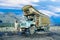 GILGIT, PAKISTAN - AUG 6, 1987: proud truck driver presents his painted truck at the karacorum highway in Pakistan. The Karakoram