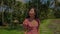 gimbal shot on young beautiful and happy Asian Chinese woman in stylish Summer dress walking on palm trees jungle