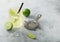 Gimlet Kamikaze cocktail in crystal glass with lime slice and ice on light board with strainer