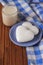 Ginger biscuits in the shape of heart on a saucer and a cup of hot chocolate on a wooden table