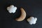 Ginger bread halfmoon and clouds against black background