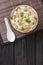 Ginger chicken Jook Rice Porridge close-up in a bowl. Vertical top view