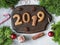 Ginger Christmas or New Year cookies in the form of numbers 2019 on a dark wood board on gray background. top view. Seasonal packa