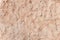 Ginger colored uneven sandstone background with cracks