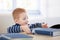 Ginger-haired little boy with encyclopedia smiling