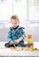 Ginger-haired toddler playing on floor