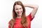 Ginger-haired woman posing against white background