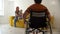 Ginger mother brings her baby son to her husband in a wheelchair