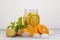 Ginger orange ice tea with mint in a glass jar, white background