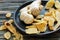 Ginger root and candied ginger on a wooden plate.