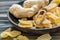 Ginger root and candied ginger on a wooden plate