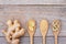 Ginger root and slices, dried ginger powder and powder capsules in wooden spoon isolated on wood table background.