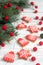 Gingerbread bells, stars, garland of felted beads and fir branches on a light background Christmas or New Year`s card.